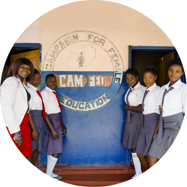 Teacher with girls outside school